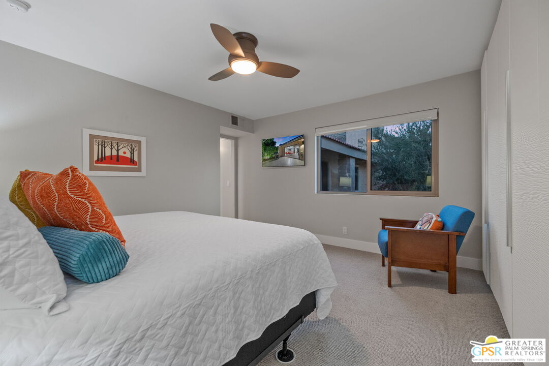 70100 Mirage Cove Drive, Unit 10 Rancho Mirage, CA 92270 - Photo 10 of 68 a bedroom with a bed and a painting on the wall