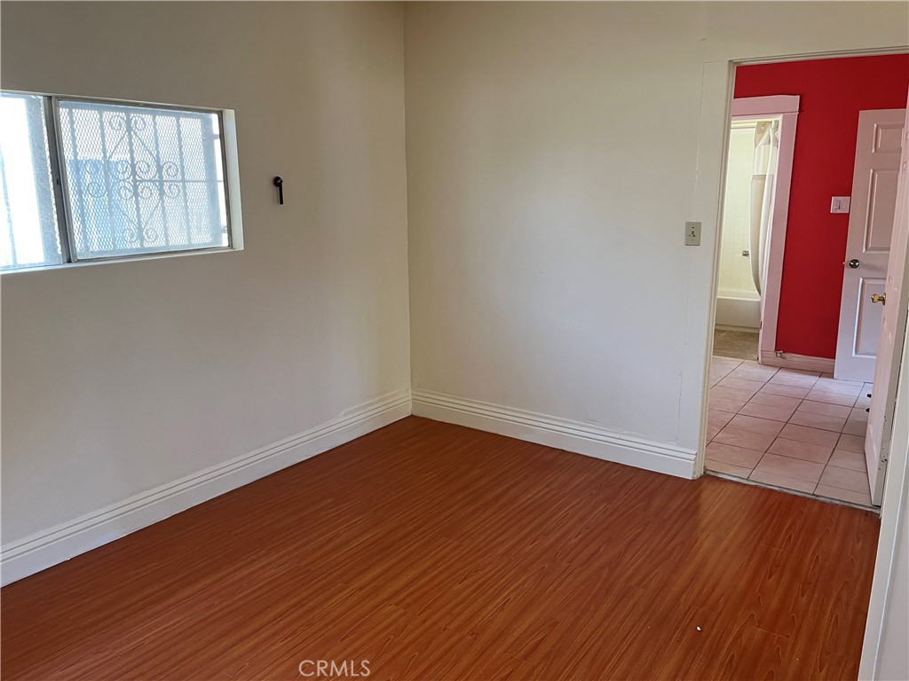 7763 Compton Avenue Los Angeles, CA 90001 - Photo 18 of 20 an empty room with wooden floor and windows