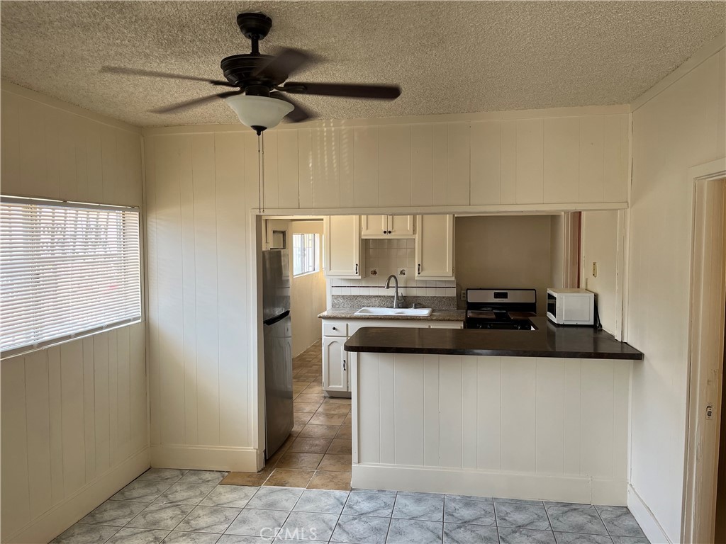 7763 Compton Avenue Los Angeles, CA 90001 - Photo 10 of 20 a kitchen with a sink appliances and cabinets