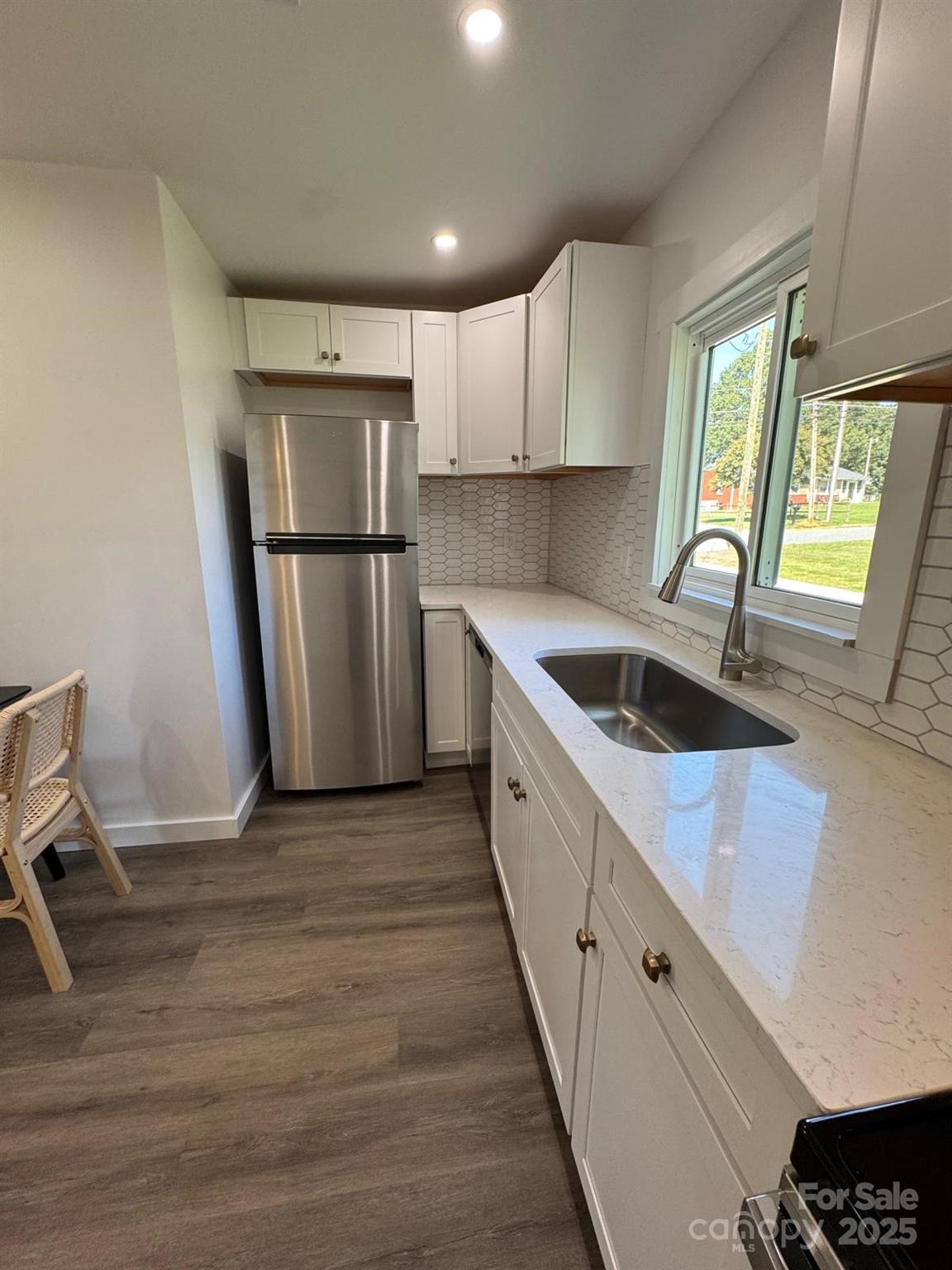 1018 Union Street Maiden, NC 28650 - Photo 13 of 46 a kitchen with a sink a refrigerator and window