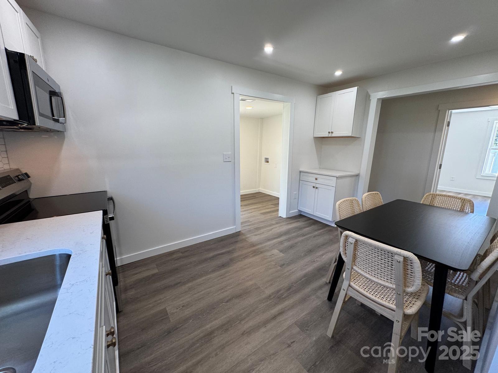 1018 Union Street Maiden, NC 28650 - Photo 14 of 46 a kitchen with a table chairs refrigerator and microwave
