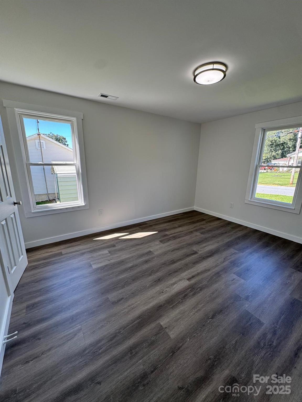 1018 Union Street Maiden, NC 28650 - Photo 17 of 46 an empty room with wooden floor and windows