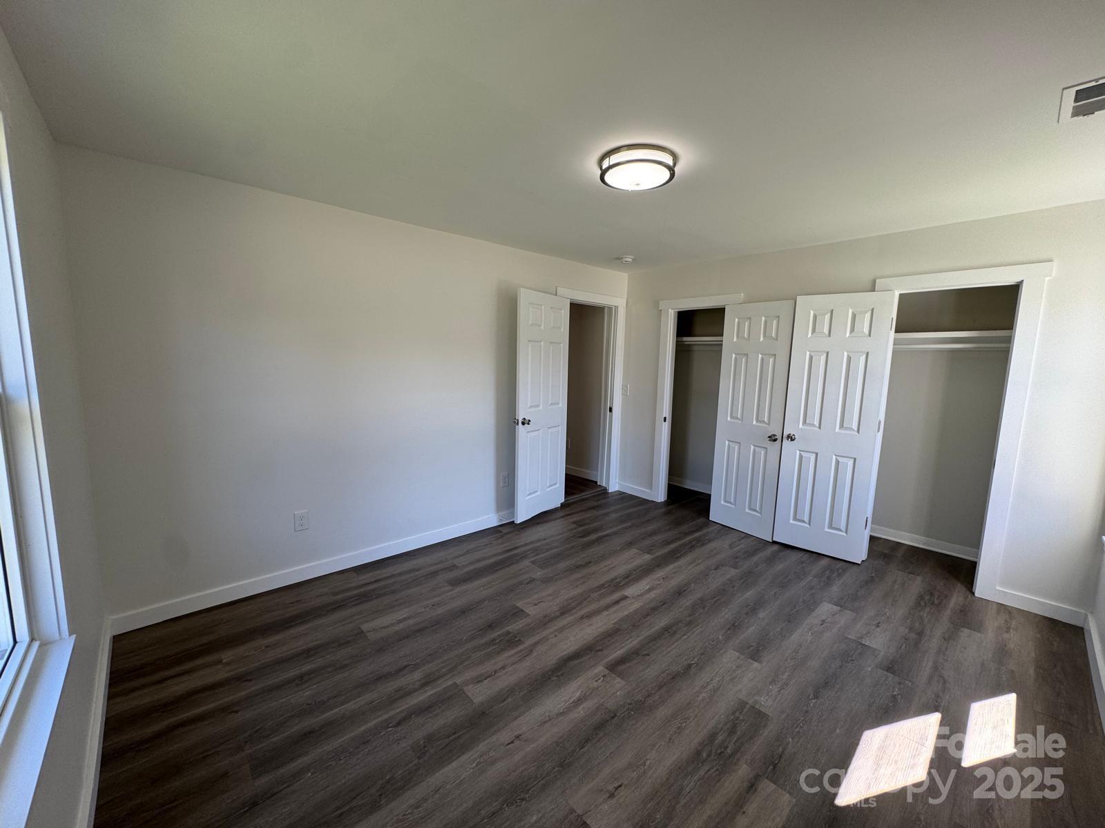 1018 Union Street Maiden, NC 28650 - Photo 18 of 46 a view of an empty room with wooden floor and a window