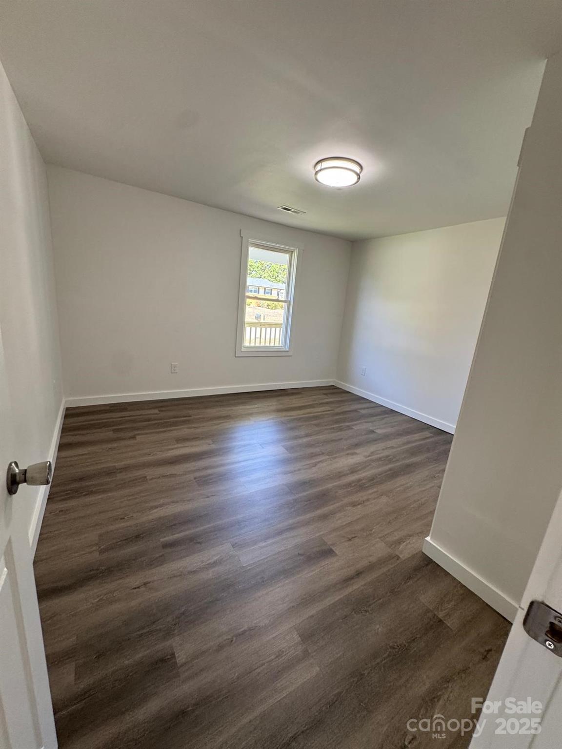 1018 Union Street Maiden, NC 28650 - Photo 19 of 46 an empty room with wooden floor and windows