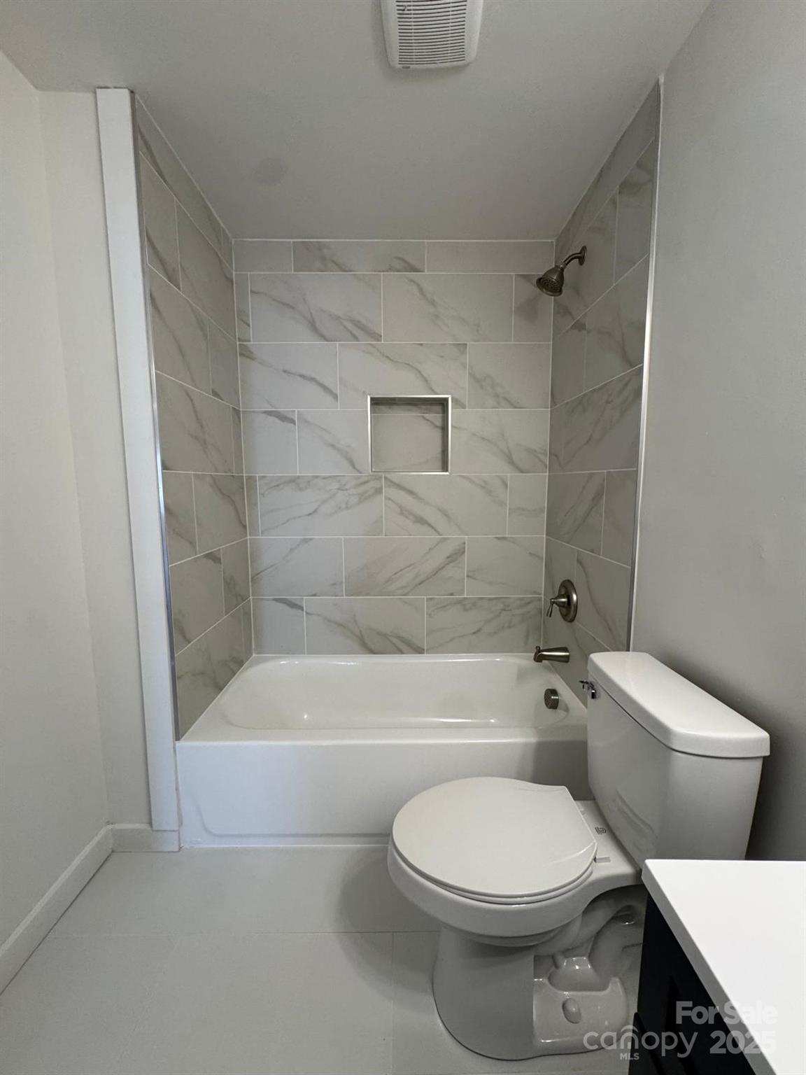 1018 Union Street Maiden, NC 28650 - Photo 21 of 46 a white toilet and tub sitting next to a bathroom sink