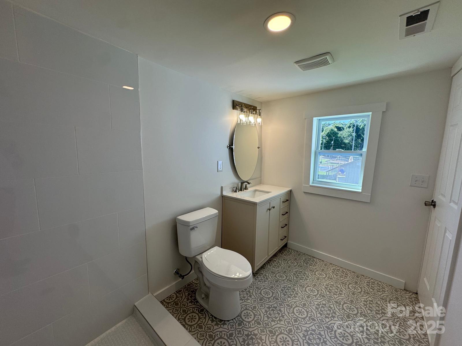 1018 Union Street Maiden, NC 28650 - Photo 27 of 46 a white toilet sitting next to a bathroom sink