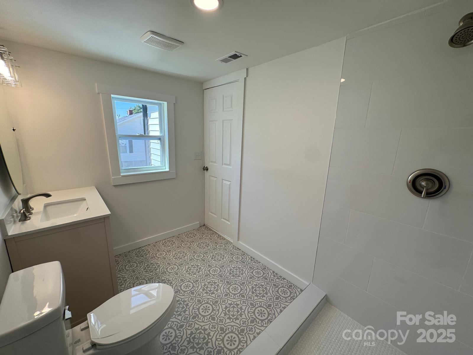 1018 Union Street Maiden, NC 28650 - Photo 28 of 46 a bathroom with a granite countertop toilet and a sink