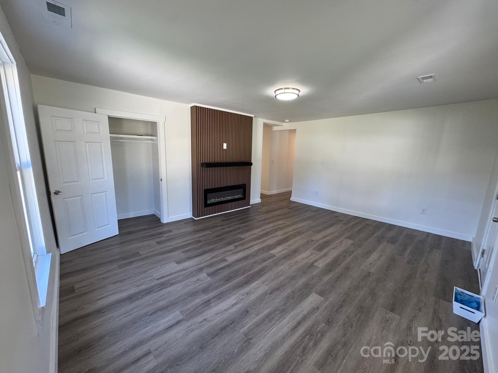 1018 Union Street Maiden, NC 28650 - Photo 7 of 46 an empty room with wooden floor and windows