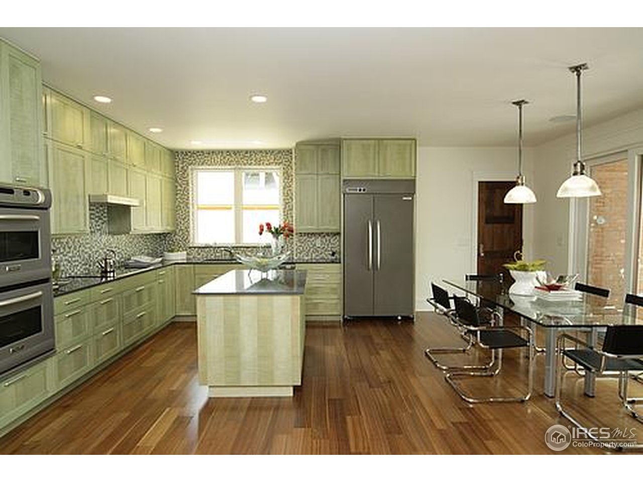 429 Spruce Street Boulder, CO 80302 - Photo 12 of 25 a kitchen with stainless steel appliances granite countertop a refrigerator a sink dishwasher a stove and a dining table with wooden floor