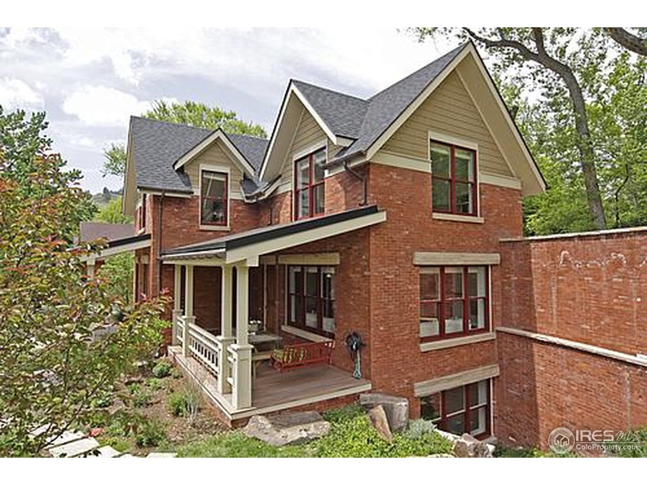 429 Spruce Street Boulder, CO 80302 - Photo 3 of 25 a view of a white house next to a yard