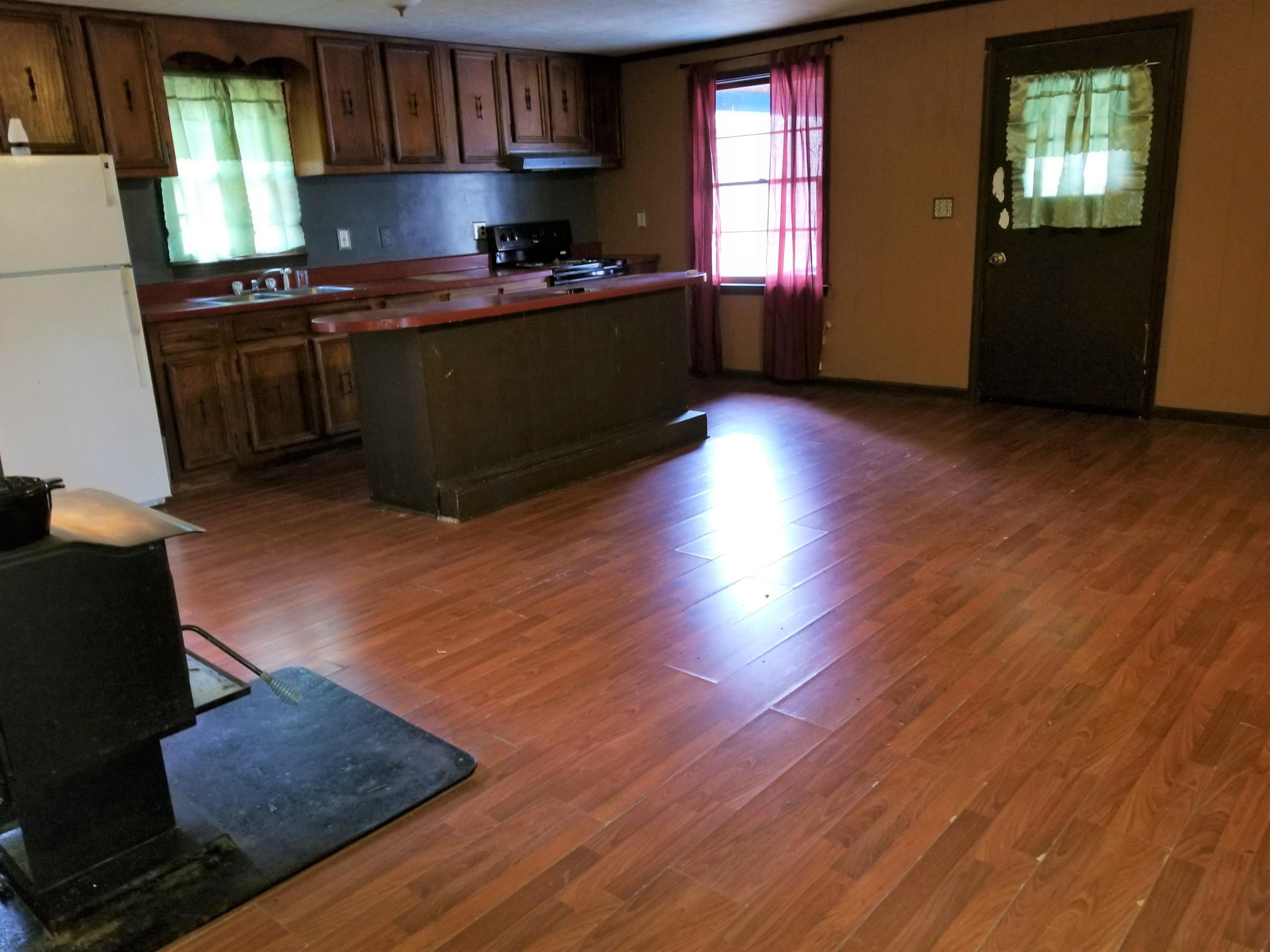 156 Prillaman Switch Road Ferrum, VA 24088 - Photo 5 of 24 a kitchen with granite countertop wooden floors and a sink