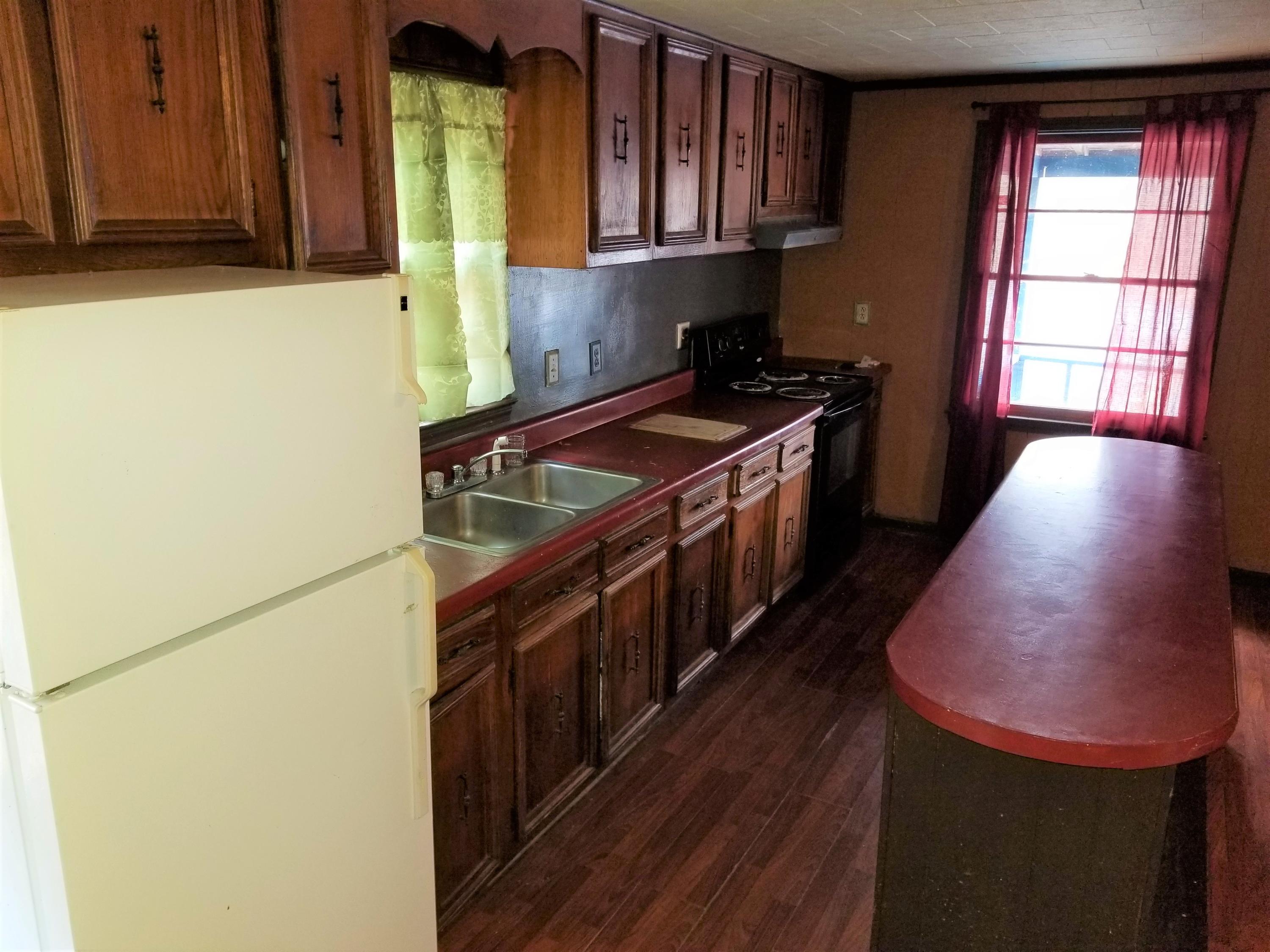 156 Prillaman Switch Road Ferrum, VA 24088 - Photo 8 of 24 a kitchen with stainless steel appliances granite countertop a stove a sink and a refrigerator