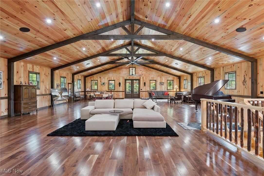 290 Townline Road Aurora, OH 44202 - Photo 9 of 50 Living room featuring wooden walls, hardwood / wood-style floors, and healthy amount of natural light