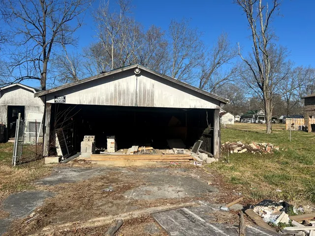 a view of house with yard and covered with snow