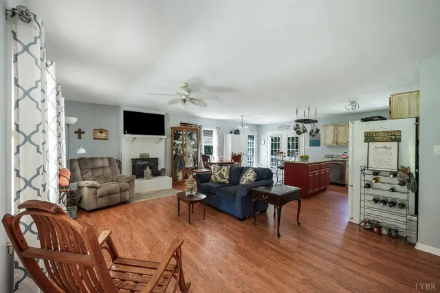 a living room with furniture and kitchen view