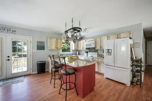 a view of a hallway with elevator and wooden floor