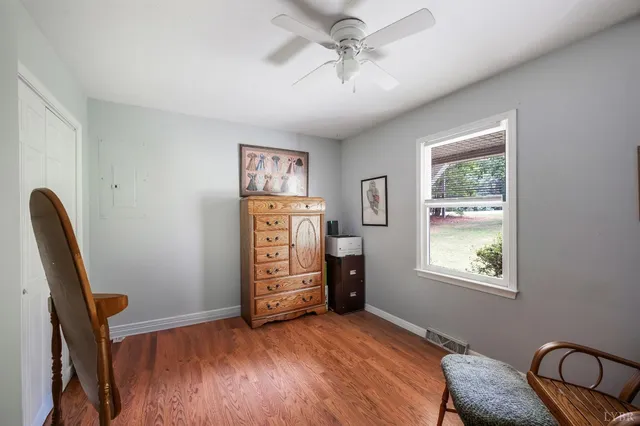 a view of a room with wooden floor and outdoor seating