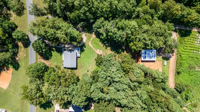 an aerial view of a house with a yard