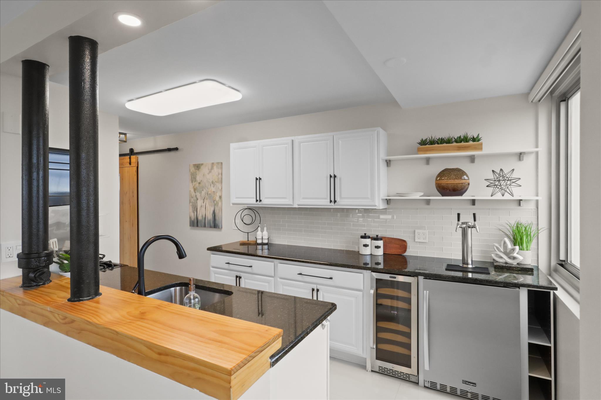 301 North Beauregard Street, Unit 1605 Alexandria, VA 22312 - Photo 13 of 42 a kitchen with a stove a sink and a stove next to a window