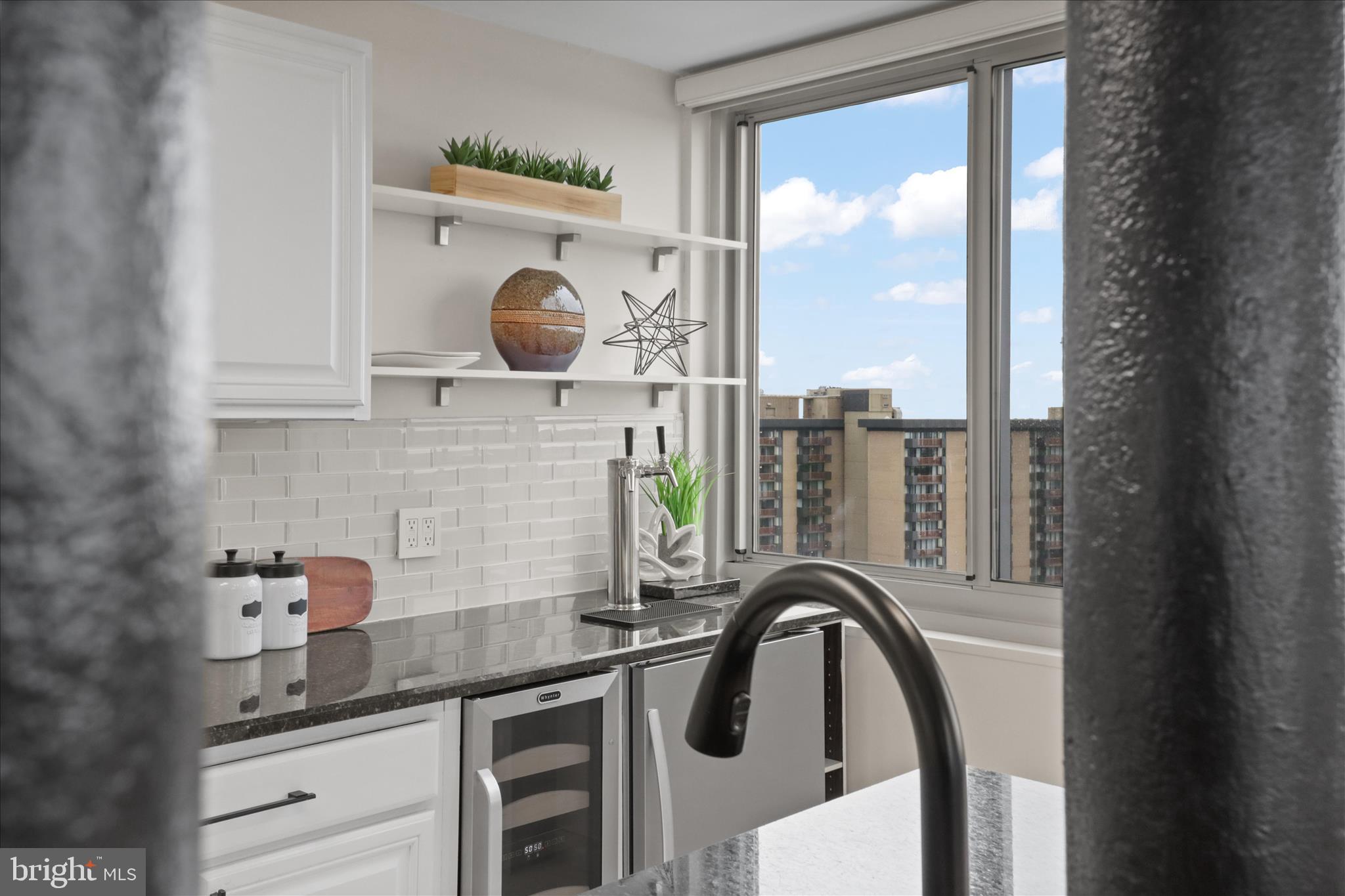 301 North Beauregard Street, Unit 1605 Alexandria, VA 22312 - Photo 14 of 42 a kitchen with a table and a large window