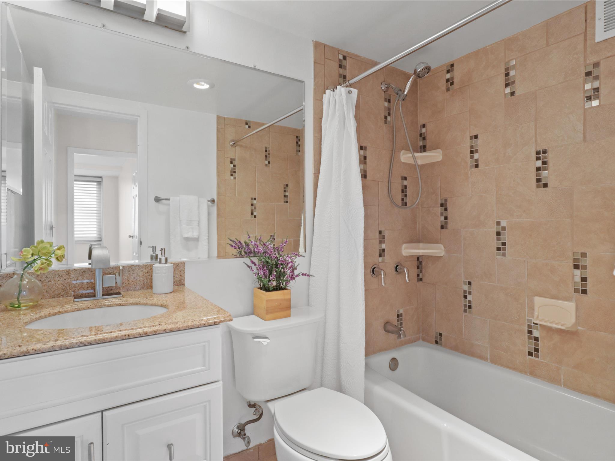 301 North Beauregard Street, Unit 1605 Alexandria, VA 22312 - Photo 24 of 42 a bathroom with a granite countertop sink toilet and shower