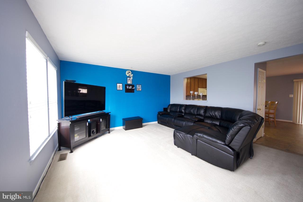 9701 Selfridge Road Baltimore, MD 21220 - Photo 11 of 29 a living room with furniture and a flat screen tv
