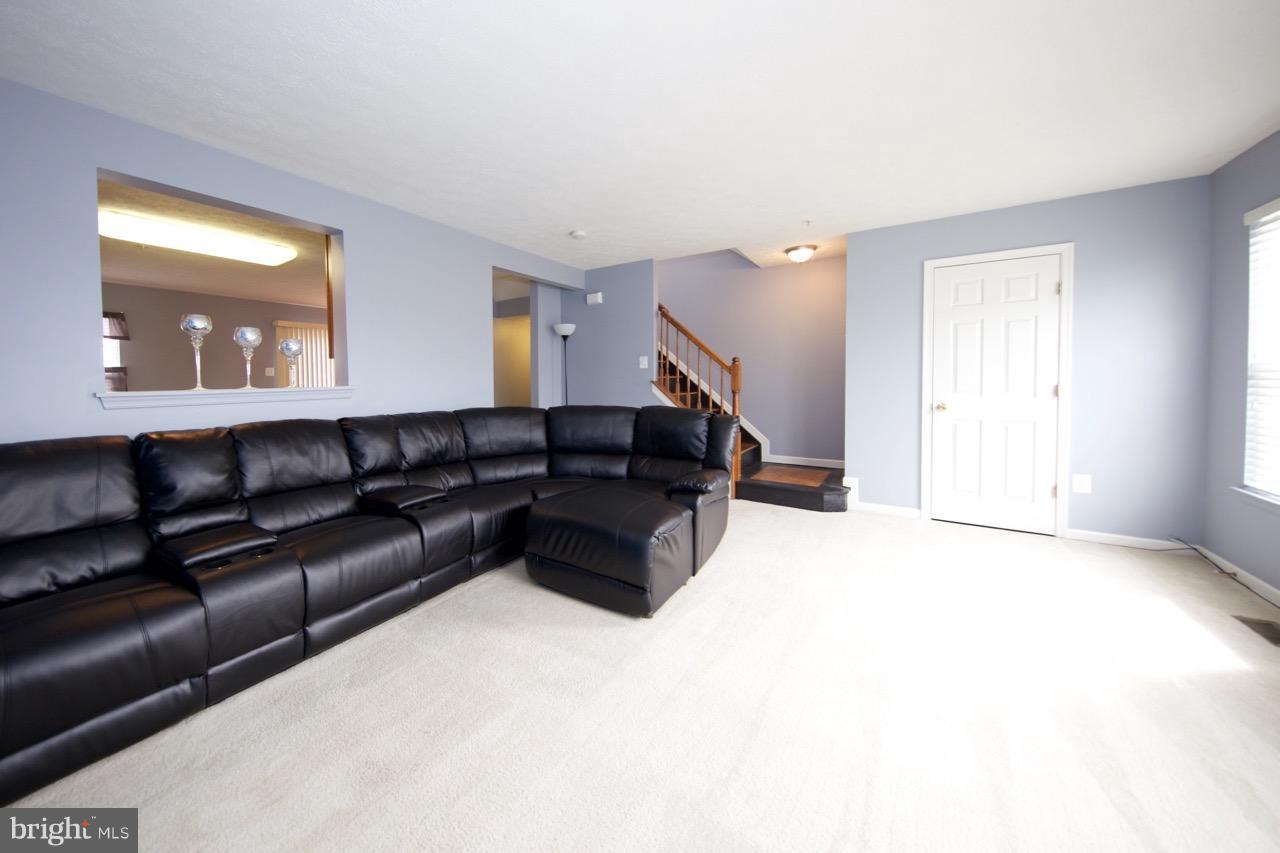 9701 Selfridge Road Baltimore, MD 21220 - Photo 14 of 29 a living room with a couch and a potted plant