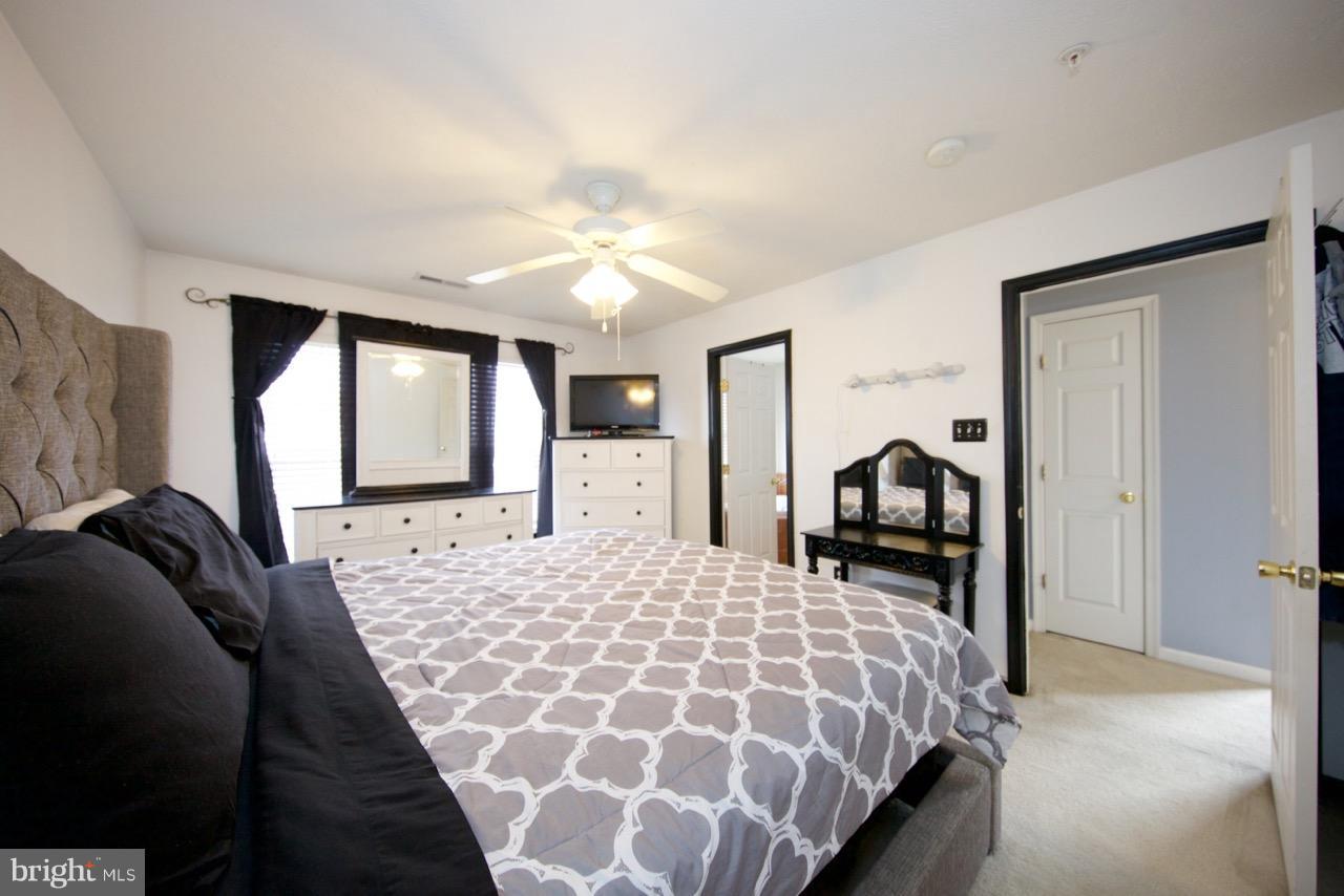 9701 Selfridge Road Baltimore, MD 21220 - Photo 16 of 29 a bedroom with a bed and a large mirror with window