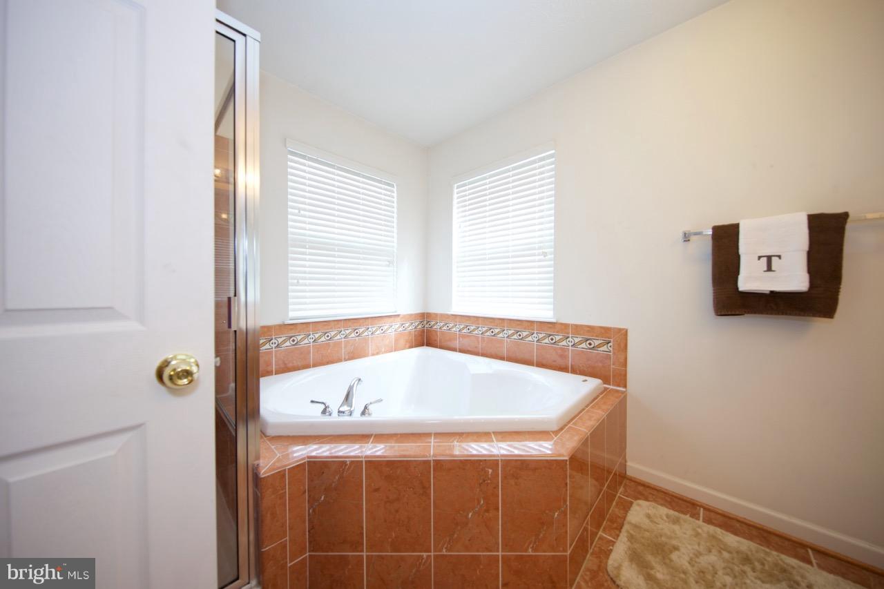 9701 Selfridge Road Baltimore, MD 21220 - Photo 19 of 29 a bath tub sitting next to a window