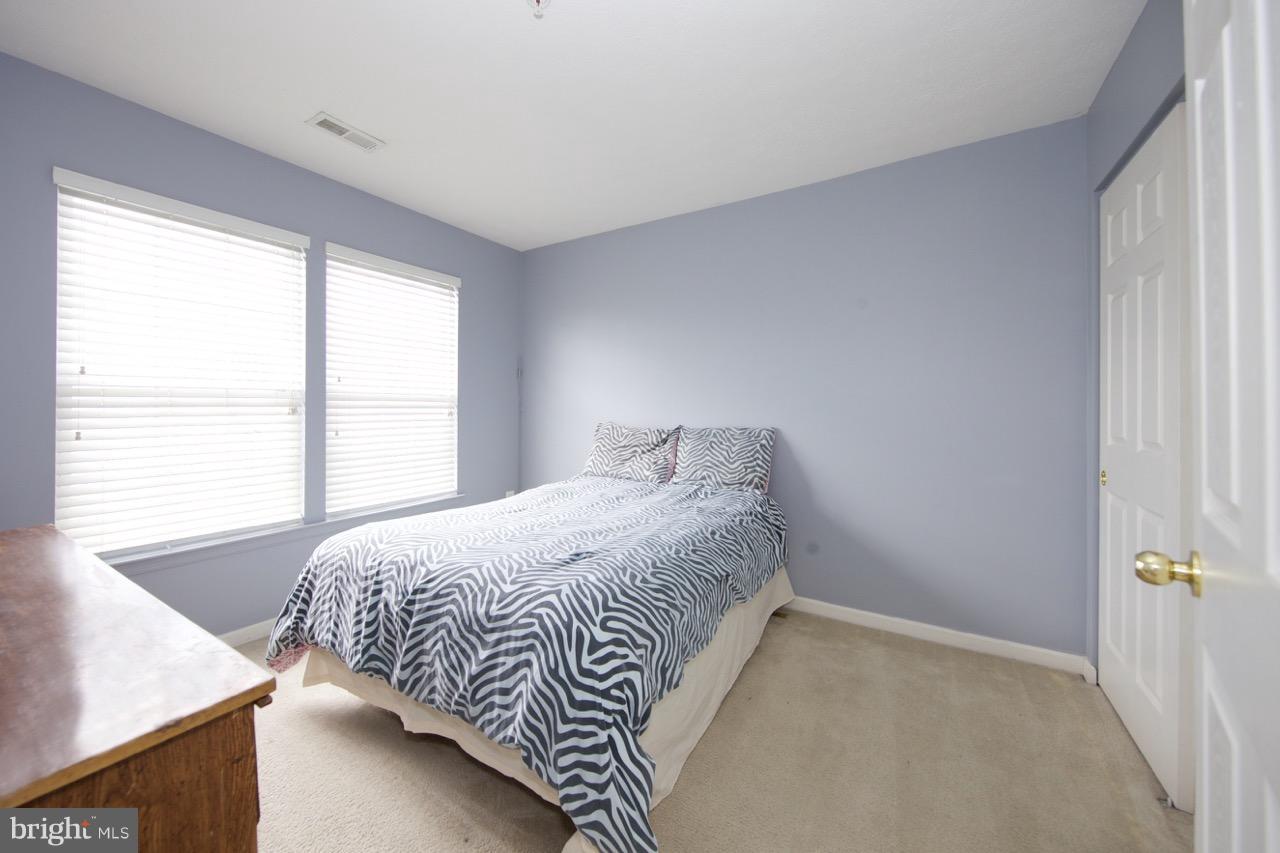 9701 Selfridge Road Baltimore, MD 21220 - Photo 20 of 29 a bed sitting in a bedroom next to a window