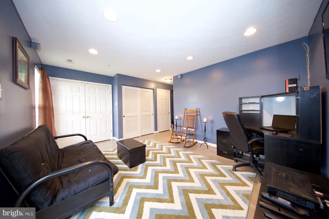 9701 Selfridge Road Baltimore, MD 21220 - Photo 26 of 29 a living room with furniture a rug and a flat screen tv