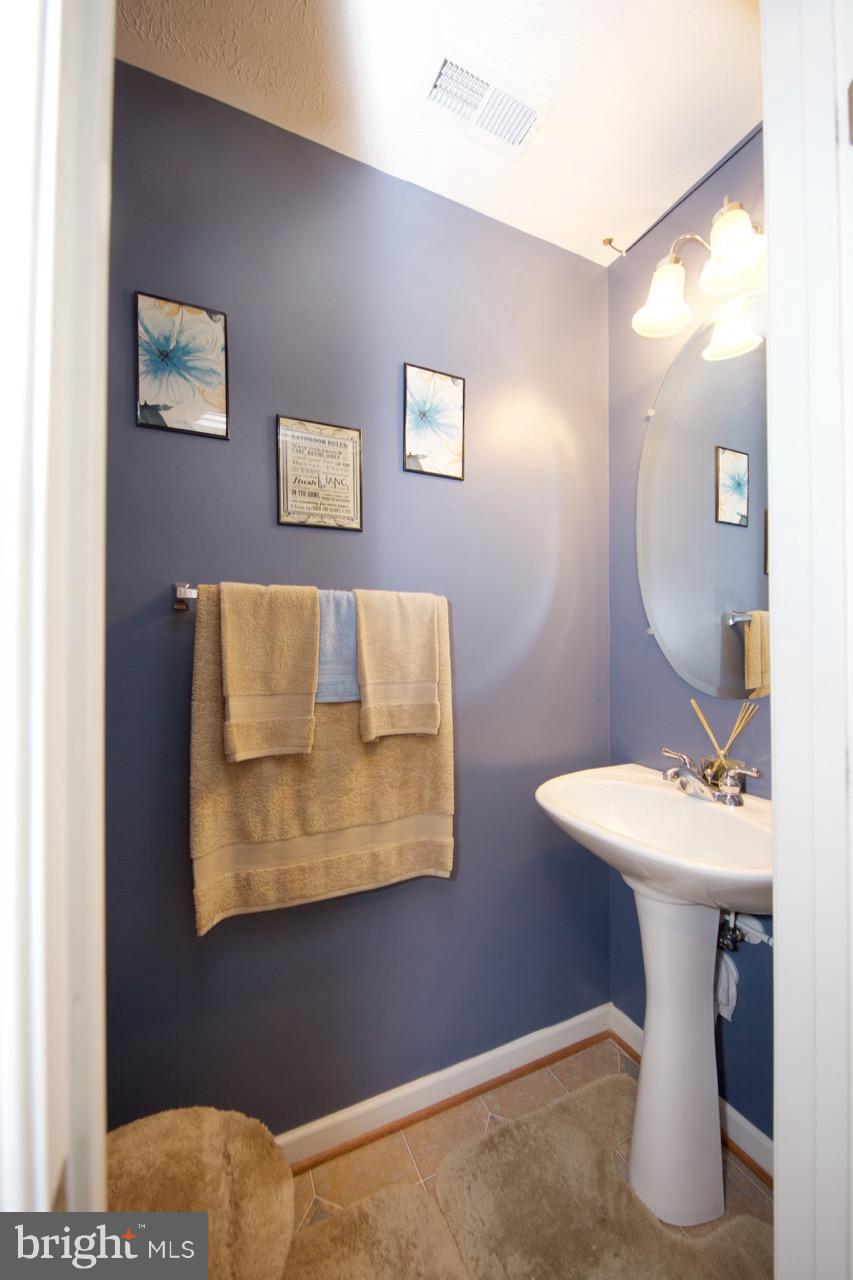 9701 Selfridge Road Baltimore, MD 21220 - Photo 4 of 29 a bathroom with a sink and a mirror