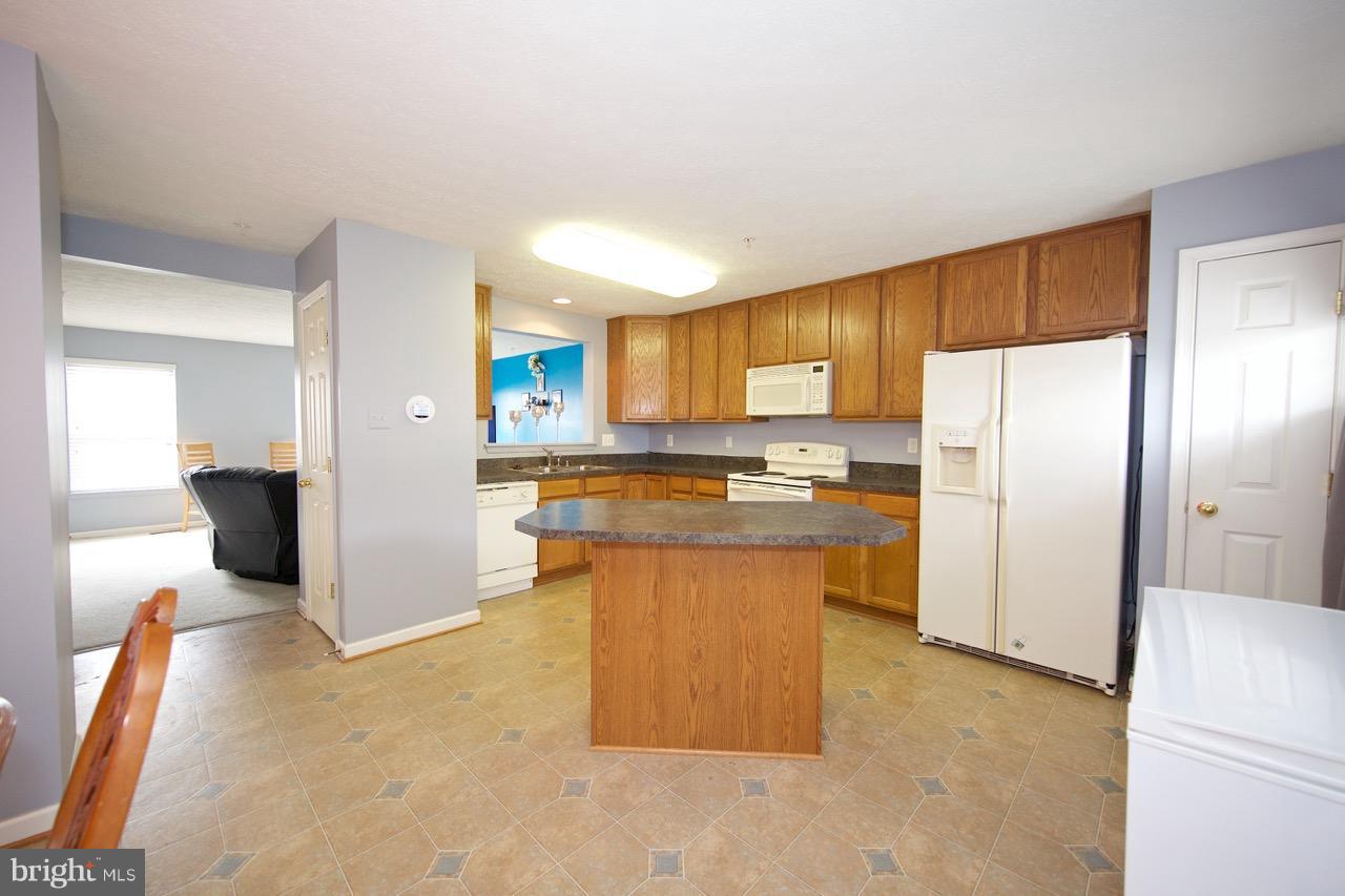 9701 Selfridge Road Baltimore, MD 21220 - Photo 6 of 29 a kitchen with stainless steel appliances granite countertop a refrigerator a stove a sink and a refrigerator