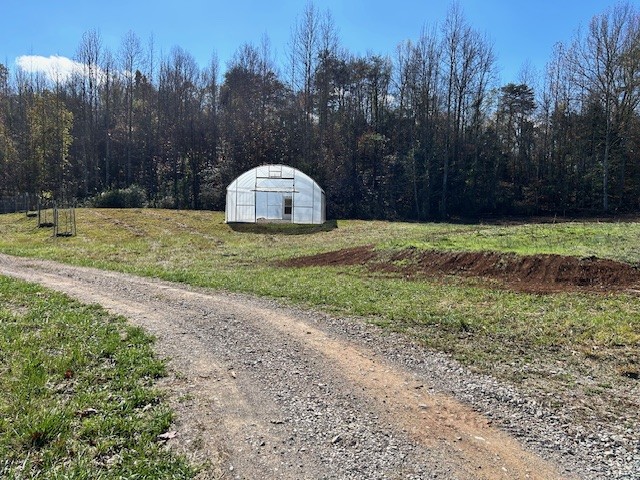 900 Ridge Road Quebeck, TN 38579 - Photo 21 of 46 a view of a tiny house with a yard and trees