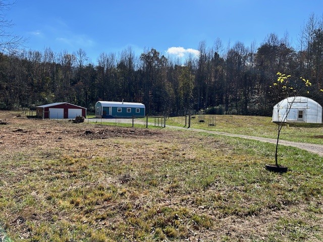 900 Ridge Road Quebeck, TN 38579 - Photo 23 of 46 a backyard of a house with table and chairs