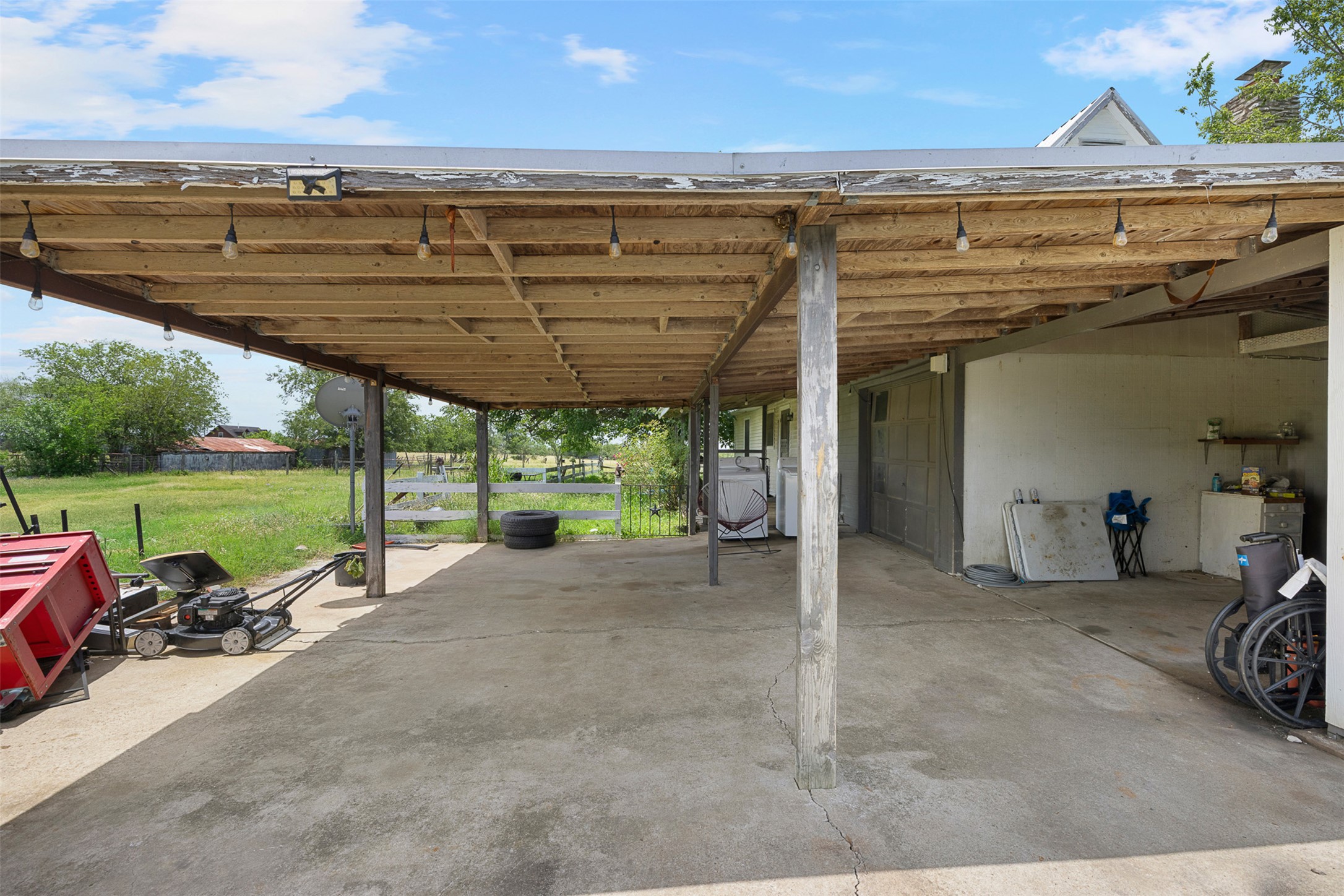 763 Upper Elgin River Road Elgin, TX 78621 - Photo 8 of 40 A spacious covered patio provides ample outdoor living space, perfect for relaxing or entertaining.