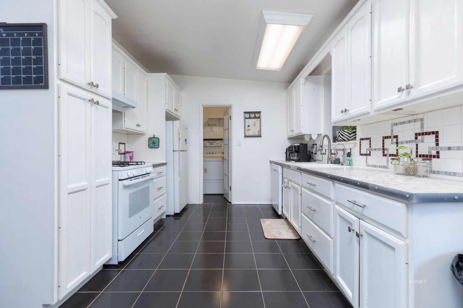 1263 South Primrose Street Ridgecrest, CA 93555 - Photo 11 of 36 a kitchen with white cabinets and white appliances