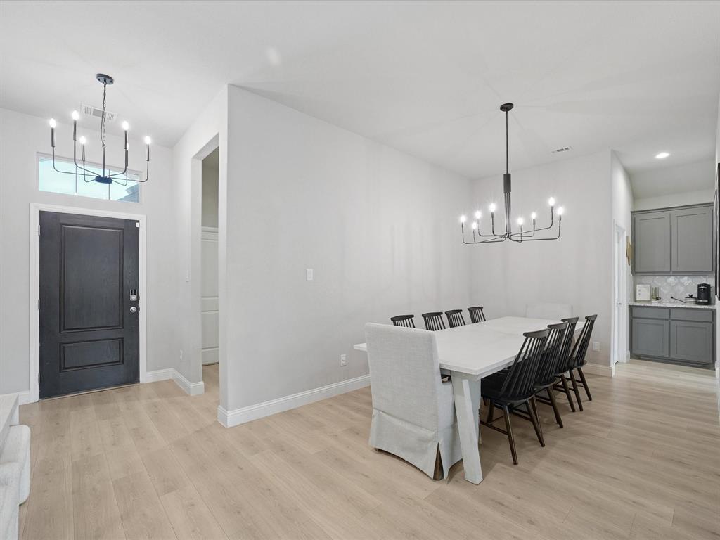 3711 Walnut Rdg Drive Grand Prairie, TX 76065 - Photo 11 of 24 a view of a dining room with furniture and wooden floor