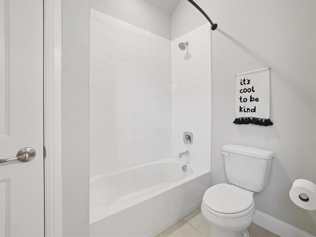 3711 Walnut Rdg Drive Grand Prairie, TX 76065 - Photo 17 of 24 a white toilet sitting next to a bath tub