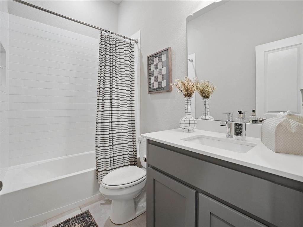 3711 Walnut Rdg Drive Grand Prairie, TX 76065 - Photo 18 of 24 a bathroom with a sink a toilet and shower