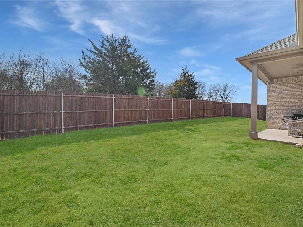 3711 Walnut Rdg Drive Grand Prairie, TX 76065 - Photo 23 of 24 a view of a backyard with a trampoline