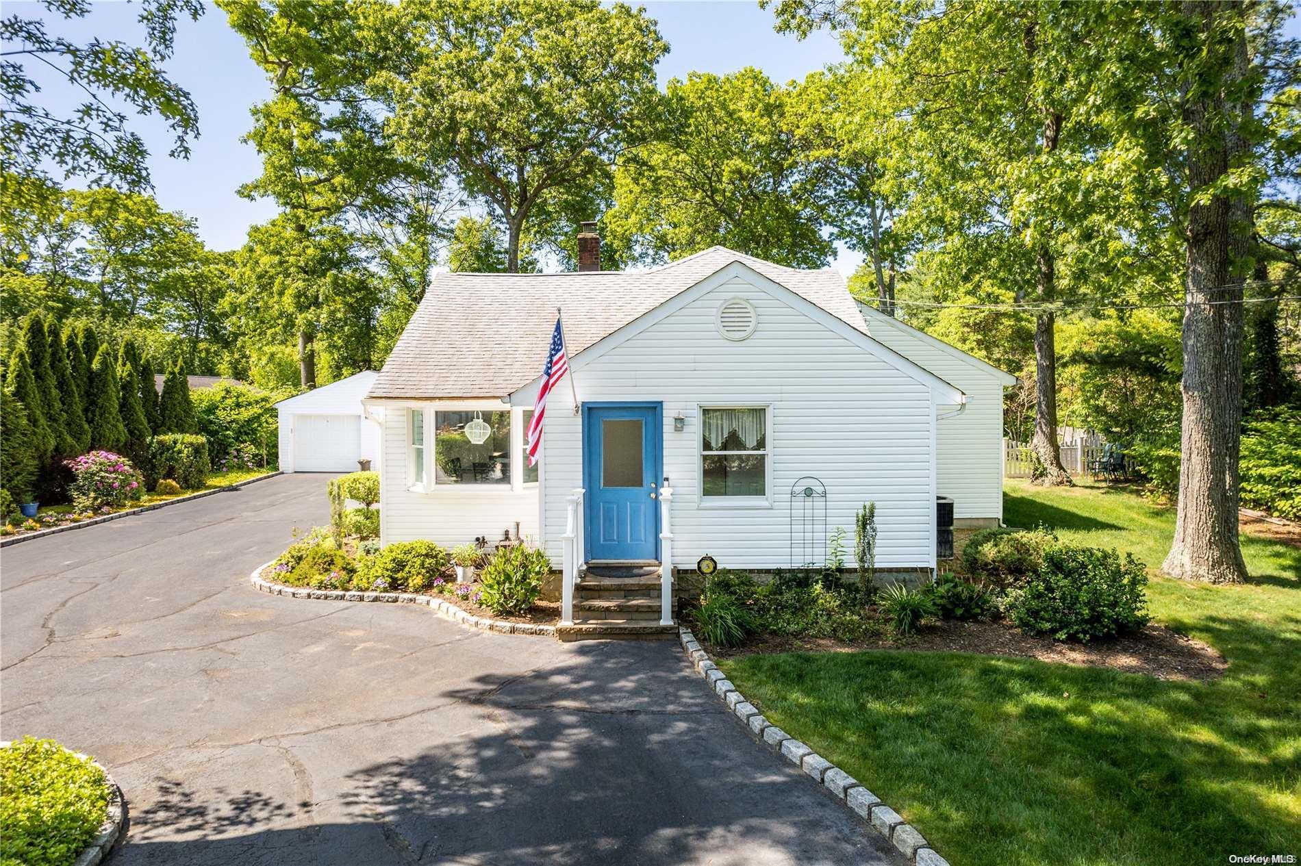a front view of a house with a yard and a garage