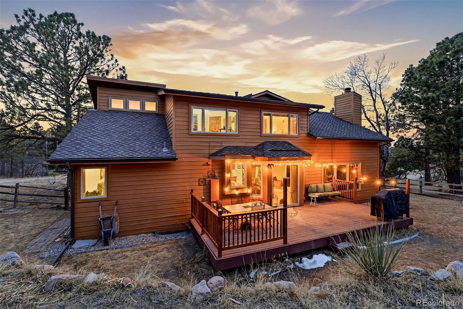 8915 Mad River Road Parker, CO 80134 - Photo 33 of 45 a front view of a house with a yard outdoor seating and garage