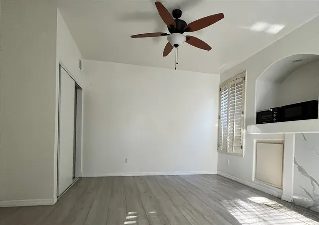 wooden floor in an empty room with a window