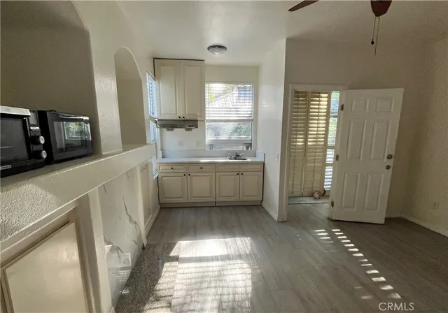 a bathroom with a sink mirror and a shower