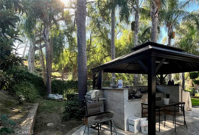 a view of patio with chairs and potted plants
