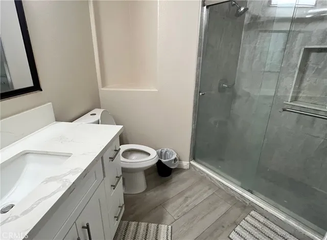 a bathroom with a sink a toilet and shower
