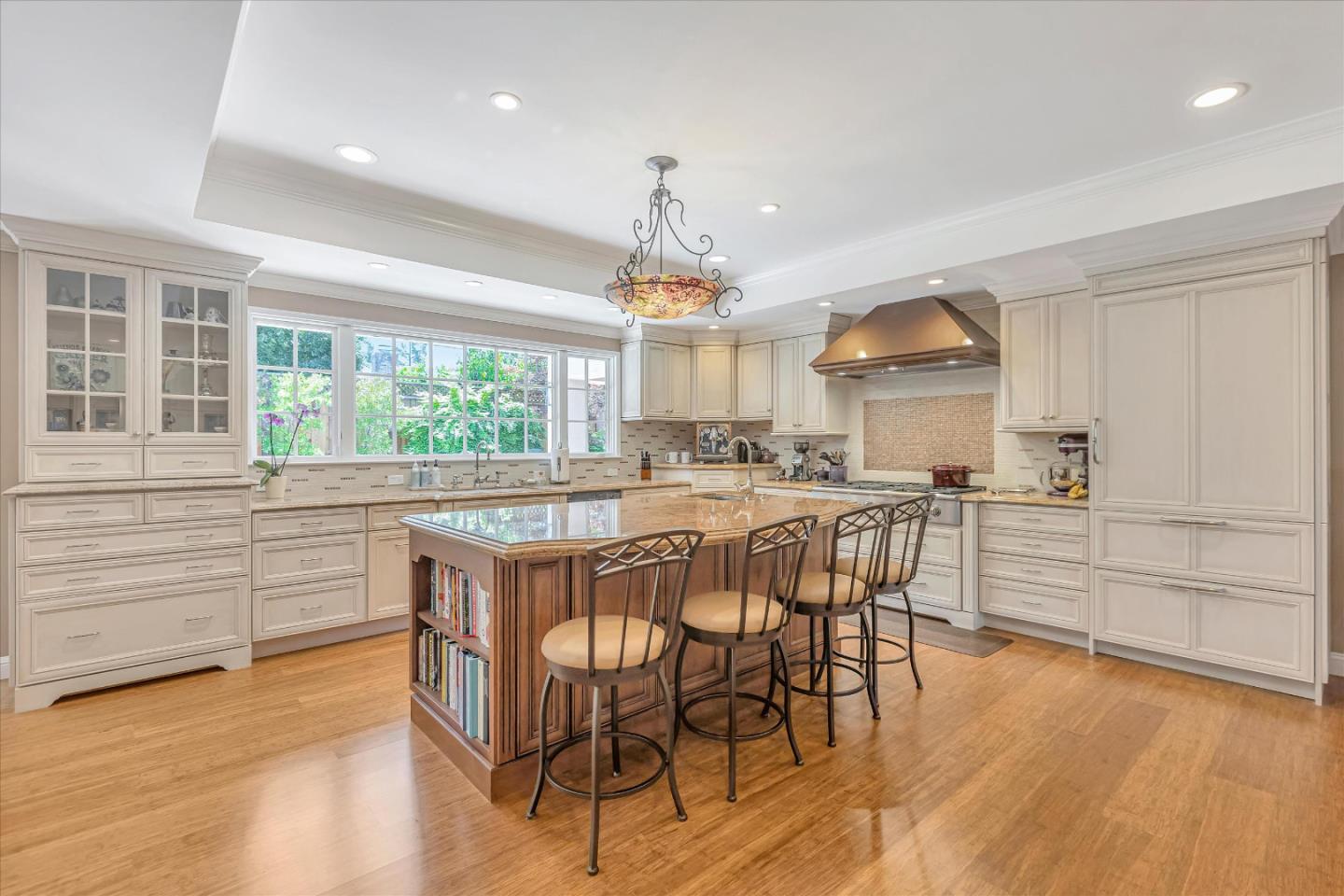 1929 Fordham Way Mountain View, CA 94040 - Photo 11 of 45 a kitchen with stainless steel appliances granite countertop a stove a refrigerator a kitchen island a stove and a wooden floors