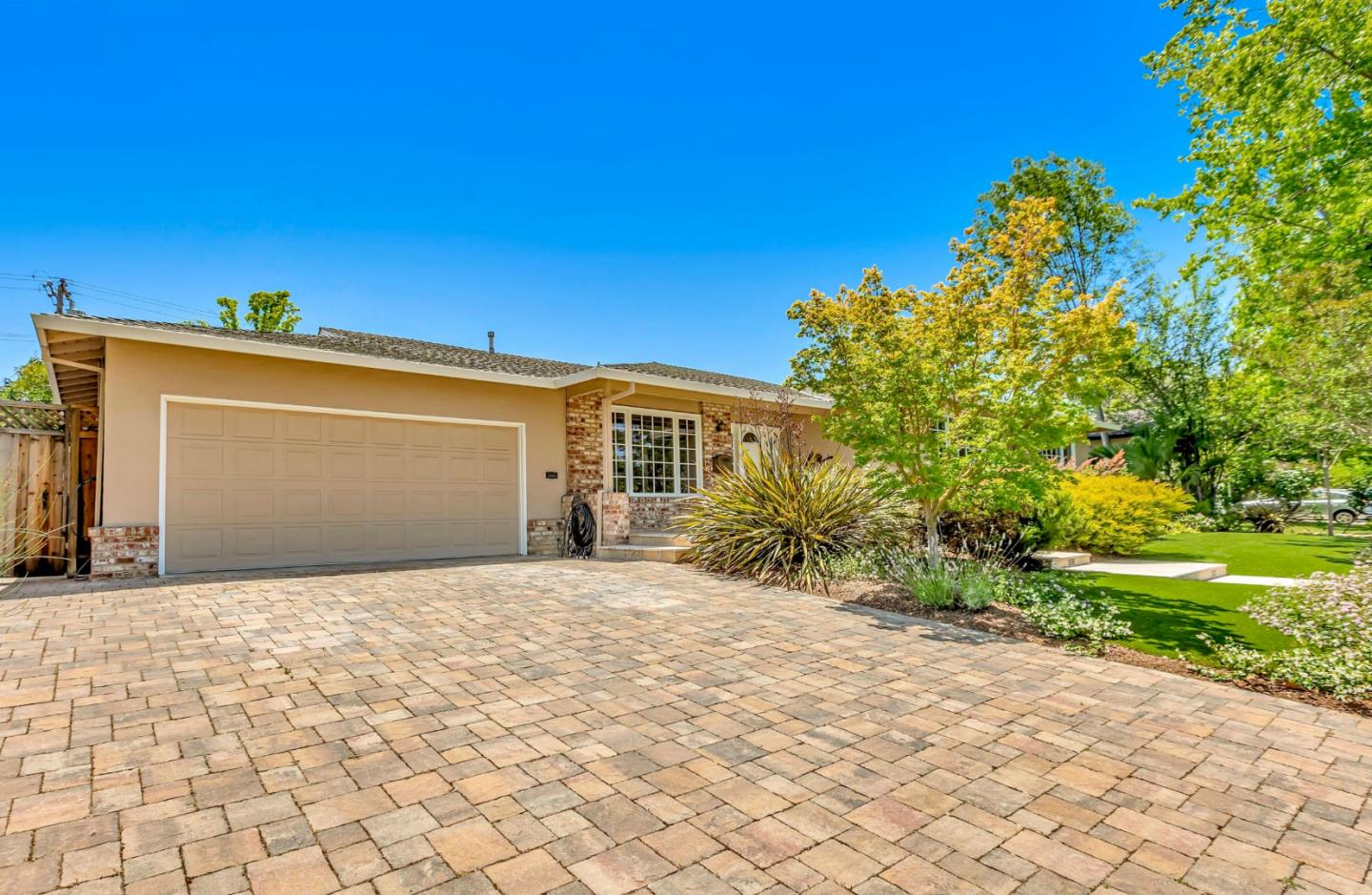 1929 Fordham Way Mountain View, CA 94040 - Photo 4 of 45 a front view of a house with a yard and garage
