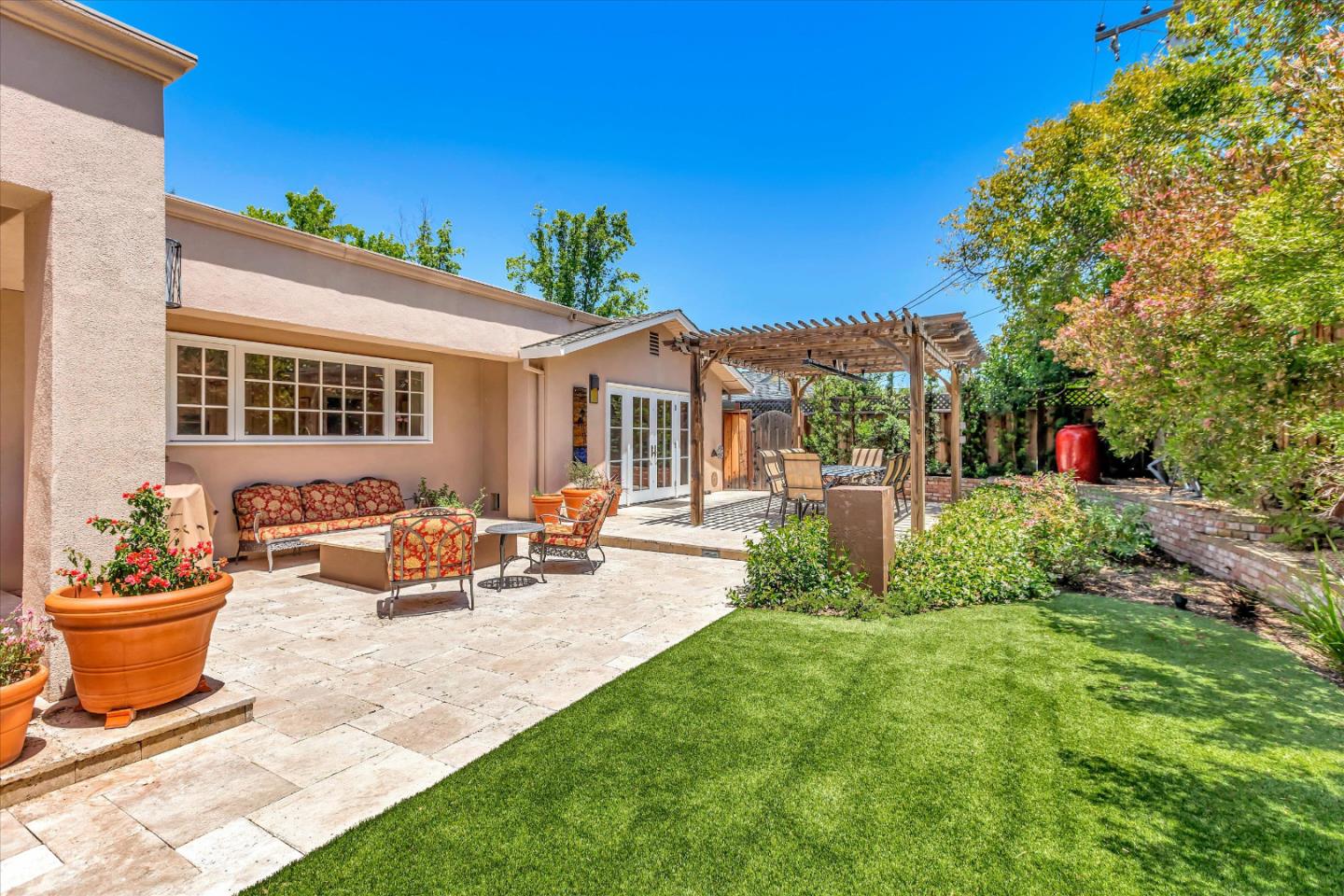 1929 Fordham Way Mountain View, CA 94040 - Photo 41 of 45 a view of a backyard with table and chairs potted plants and a small yard